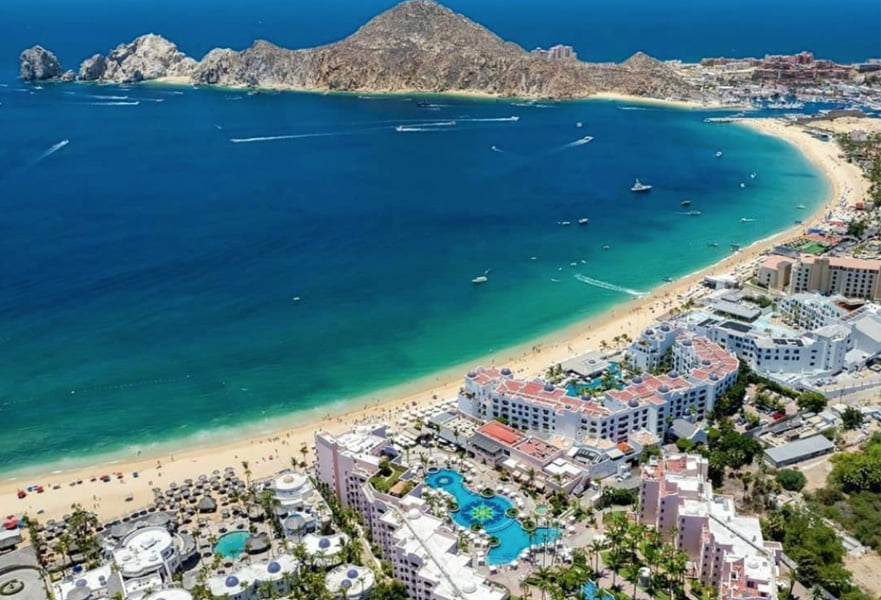 Medano beach seashore with hotels and resorts along the coast of Cabo San Lucas, Mexico.