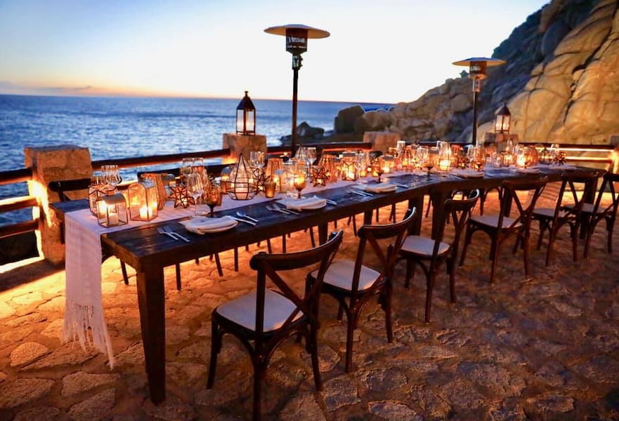 El Farallon restaurant decorated table overlooking the ocean in Cabo San Lucas Mexico.