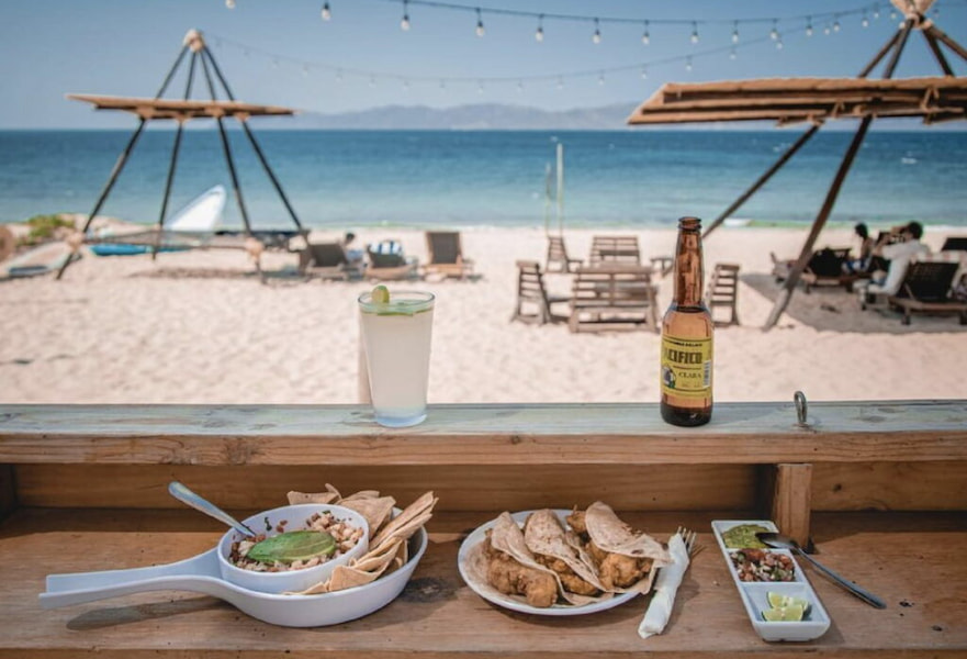 Seafood ceviche, fish tacos, lemonade and mexican beer served at a restaurant with ocean view in La Ventana BCS, Mexico