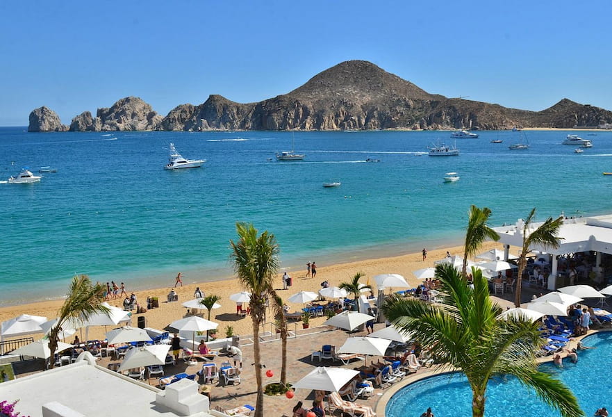 People walking on Medano swimmable beach in Cabo, Mexico.