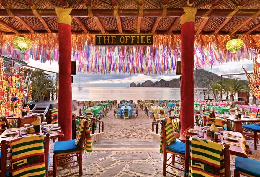 The Office on the beach main entrance in front of Medano beach with outdoor seating area overlooking the ocean