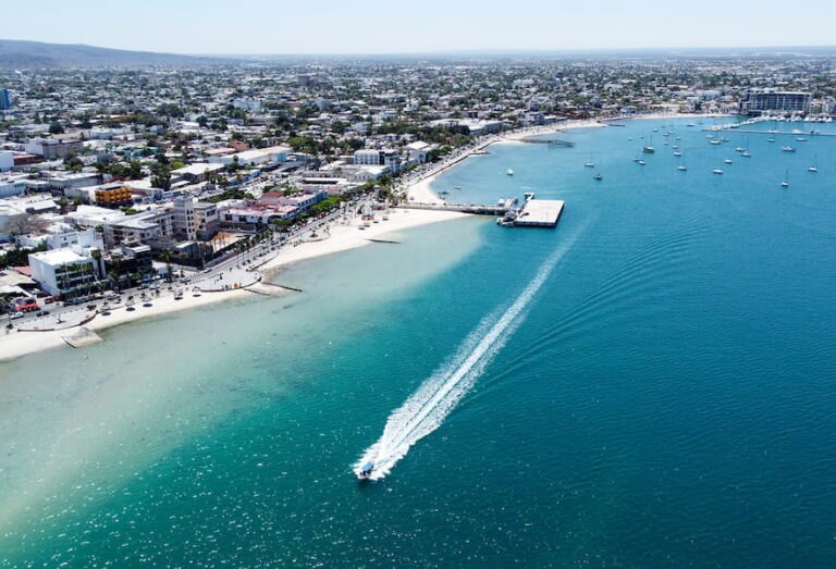 La Paz Mexico Malecon aerial view on a sunny day with sailboats and white sand and crystal clear blue waters.