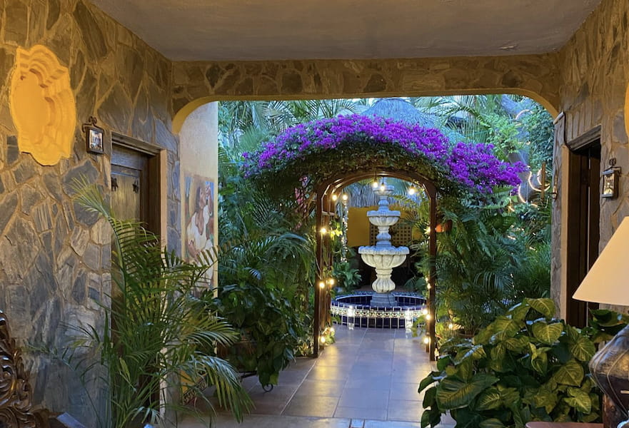 The Mexican inn B&B common area, patio with garden and fountain, Cabo San Lucas, Mexico.