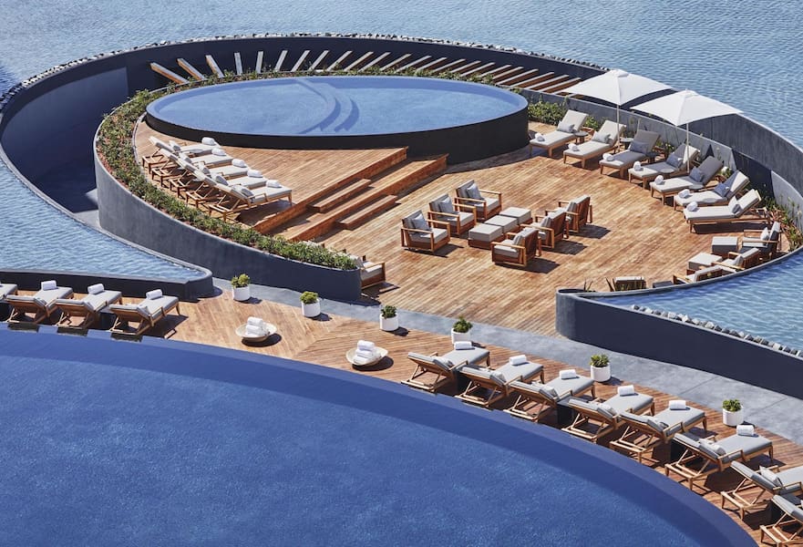 Viceroy luxury resort circular poolside with white loungers, Los Cabos, Mexico.