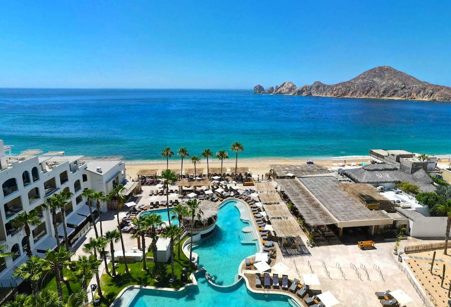Beachfront aerial view of poolside at ME Cabo Resort in Cabo San Lucas Mexico