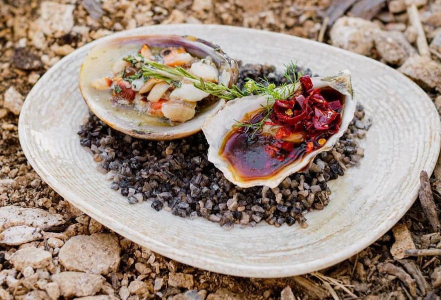 A gourmet cooked clam and oyster served in Monte Cardon, Los Cabos Mexico