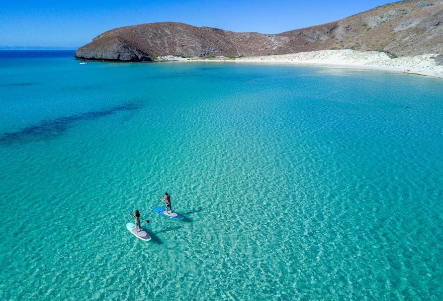 Two people paddleboarding at Balandra Beach in La Paz Baja California Sur