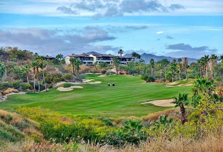 Querencia residencial area showcasing golf course with mountain background in San José del Cabo, Mexico.